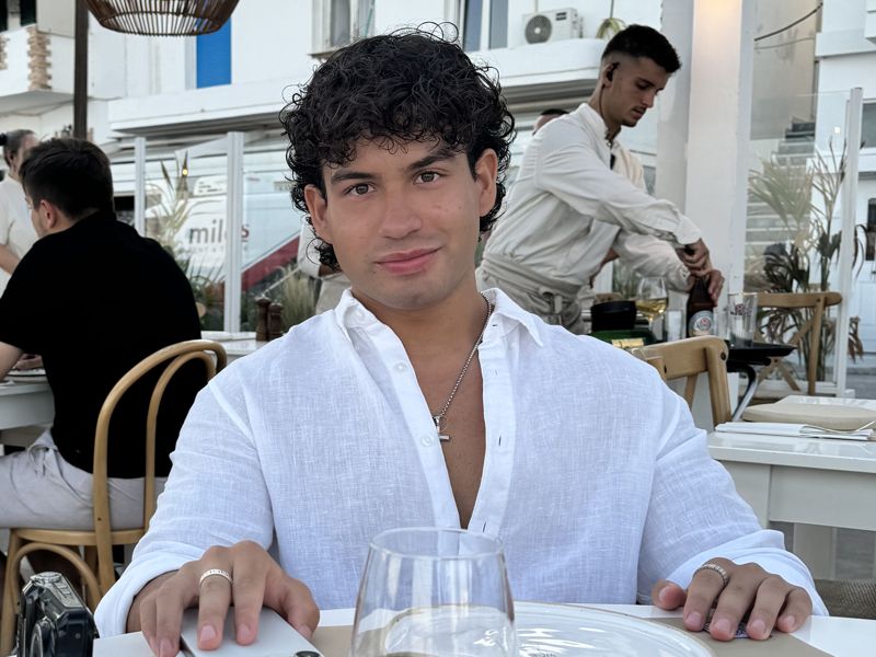 Cairo Carrillo relaxing at a café in Milos, Greece